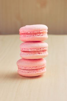 Sweet french macaroons on wooden background