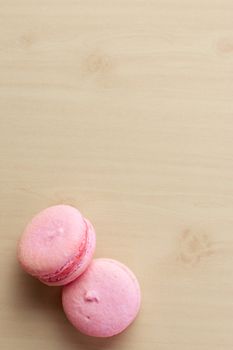 Sweet french macaroons on wooden background