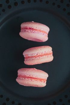 Sweet french macaroons on dark  background