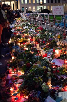 GERMANY, Berlin: Flowers, candles and other tributes are left outside the French Embassy in Berlin while the nearby Brandenburg Gate is illuminated with the colours of the French flag on November 14, 2015, the day after a series of terror attacks in Paris. Islamic State has claimed responsibility for the attacks, which killed at least 129 people and left hundreds more injured in scenes of carnage at a concert hall, restaurants and the national stadium on  Friday, November 13.