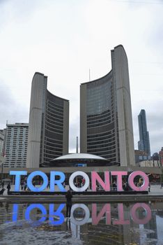 CANADA, Toronto: The Toronto sign in Nathan Phillips Square is lit up in red, white and blue, the colours of the French flag, as hundreds gather for a vigil on November 14, 2015, a day after a series of terror attacks in Paris. Islamic State has claimed responsibility for the attacks, which killed at least 129 people and left hundreds more injured in scenes of carnage at a concert hall, restaurants and the national stadium on Friday, November 13.