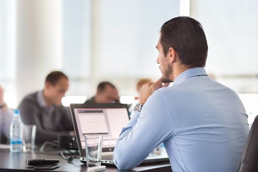 Corporate business meeting in office. Business executive giving instructions to his colleagues. Explaining business plans to employees. Business team concept. Business and Entrepreneurship. 