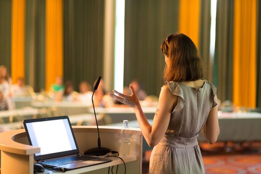 Female speaker at Business Conference and Presentation. Audience at the conference hall. Business and Entrepreneurship. Business woman. Horizontal composition.