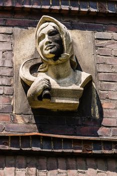 Head of a woman with a sickle sculpture on the facade of so-called Kalide Block in Bytom, Poland  - a residential quarter built in the twenties of 20th century under the German authorities.