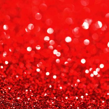 Red festive glitter background with defocused lights