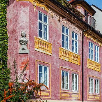 Facade of an ancient tenement in Prague, Czech Republic.