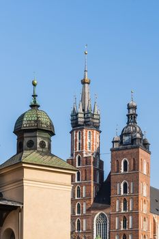 Towers of St.Mary church and the fragment of Sukienice (cloth market) in the Main Square in Krakow, Poland.