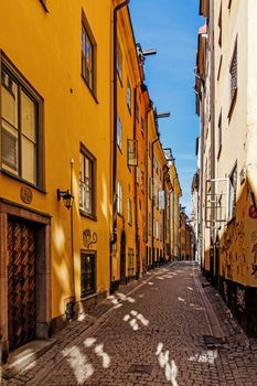 Small street on Gamla stan (The Old Town) in Stockholm. The town dates back to the 13th century and is the main attraction of the city with a rich collection of medieval architecture.