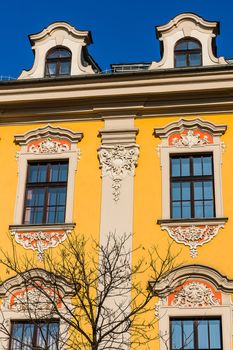 Facade of an ancient tenement in the Old Town in Krakow, Poland.