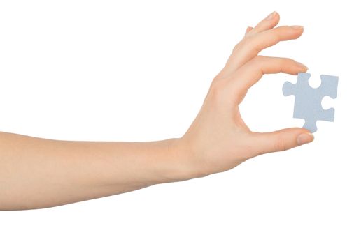 Hand holding puzzle piece on isolated white background