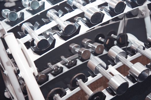 Group of barbells arranged in row at the gym. Horizontal photo