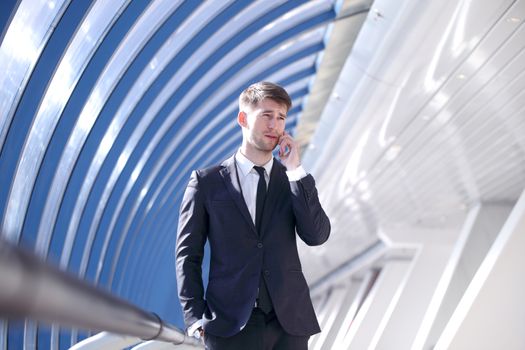 Businessman talking on the phone in modern building