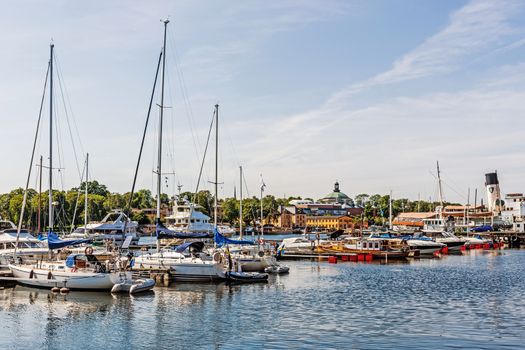 Boats moored at the Djurgarden Island in Stockholm. The Island is home to historical buildings, monuments, galleries, the amusement park Grona Lund and the open-air Skansen.