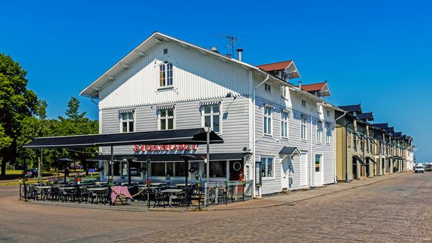 Wooden houses beside the wharf in Kalmar, city situated by the Baltic Sea with around 36k inhabitants, the seat of Kalmar Municipality and the capital of Kalmar County