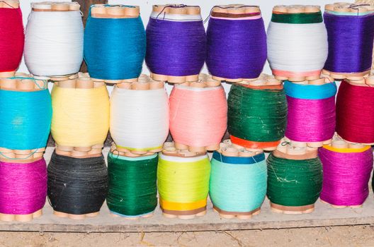 Large number of colorful cord rolls in a weaving mill