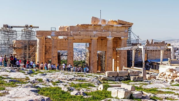 Tourists visit the Acropolis of Athens, an ancient citadel on a hill above Athens, home to several relics, a UNESCO World Heritage Site.