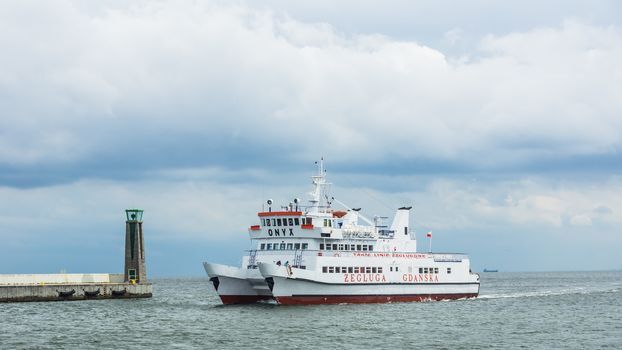 Pleasure ship approaching Port of Gdynia, the third largest seaport in Poland, specialized in handling containers, ro-ro, ferry transport, pleasure cruises, on July 10, 2013.