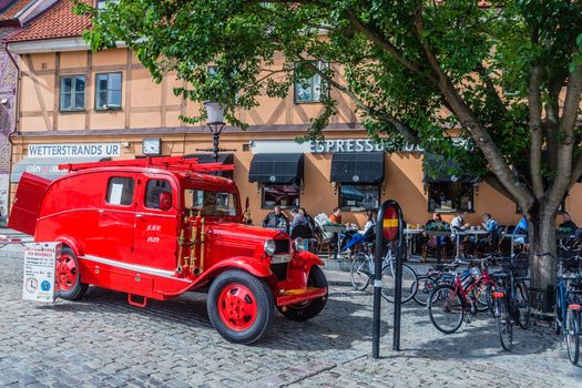 Old fire dept. car used for city tours in Ystad. City founded in 11th century is a place of action of well-known novels by Henning Mankell with detective Wallander.