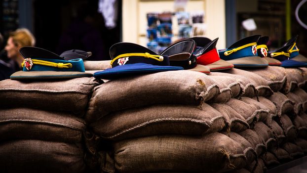 Composition of the caps of Soviet soldiers, arranged on bags of sand, on the former border point between East and West Berlin, known as Checkpoint Charlie, on 14 July 2012.