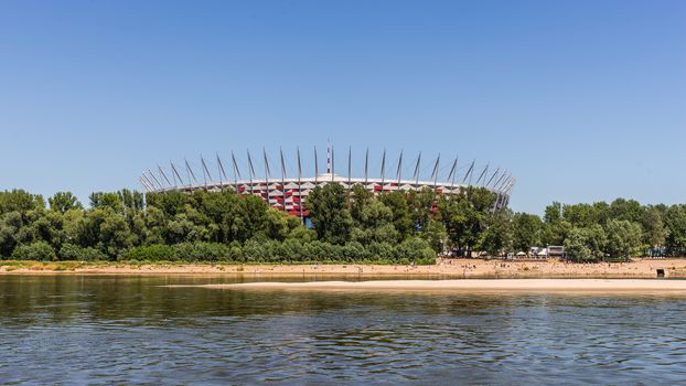 The Polish National Stadium in Warsaw preceded by the municipal beach on Vistula river. Designed and constructed for UEFA EURO 2012 tournament co-hosted by Poland and Ukraine.