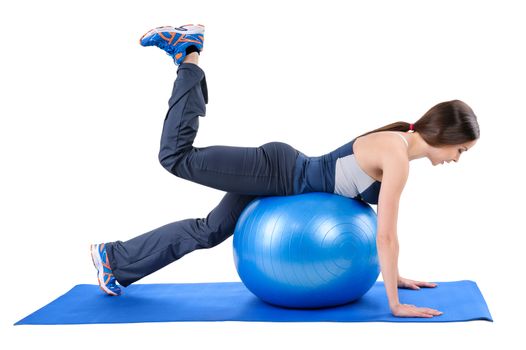 Young woman shows starting position of Fitness Stability Ball Glute Kickback Workout, isolated on white