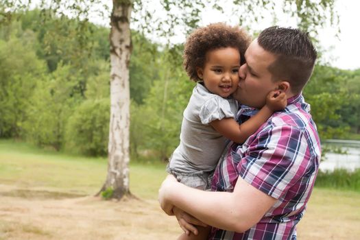 Blank father with his african daugther having a nice time