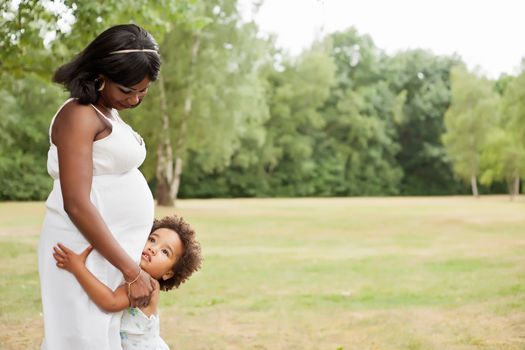 Pregnant mother and her daughter are having fun