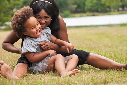 Pregnant mother and her daughter are having fun