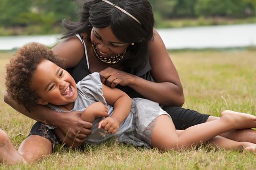 Pregnant mother and her daughter are having fun