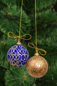 Beautiful Christmas balls on  background of green fir-tree