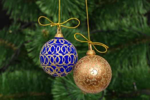 Beautiful Christmas balls on  background of green fir-tree