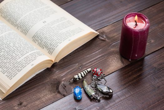 Composition of esoteric objects,candle and book used for healing and fortune-telling.