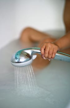 In the bathroom, a child taking a shower