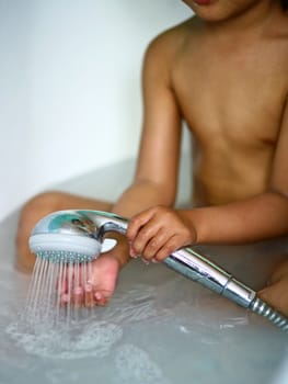 In the bathroom, a child taking a shower