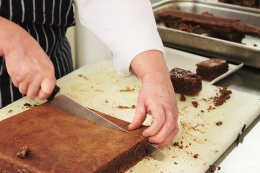 pastry chef cutting chocolate  brownies