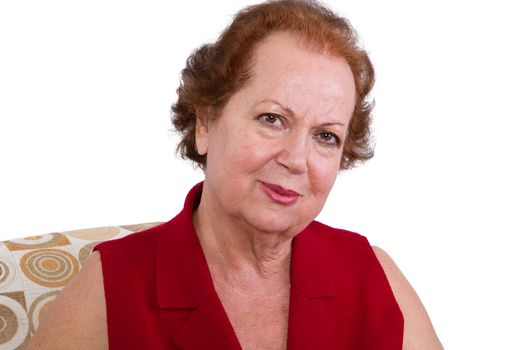 Close up Senior Woman in Red Looking at the Camera Genuinely Against White Background.