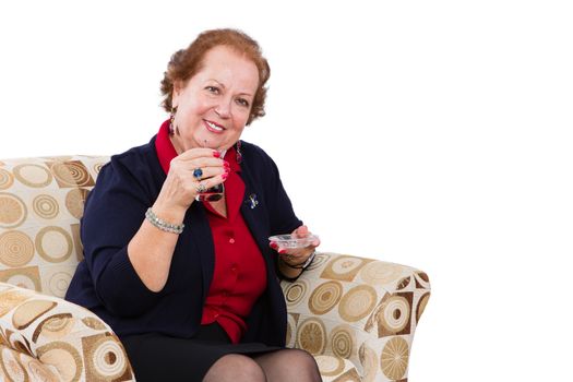 Senior Businesswoman at her Seat Inviting to Have a Tea with a Smiling Face, Isolated on White Background.