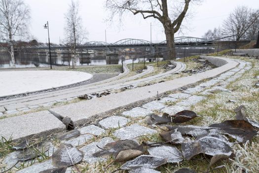 Bridge in Umeå, Sweden with leaves and river.