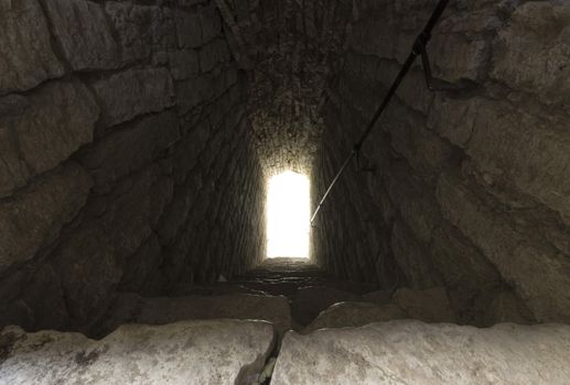 Staircase Leading Into Light with rocks all around.