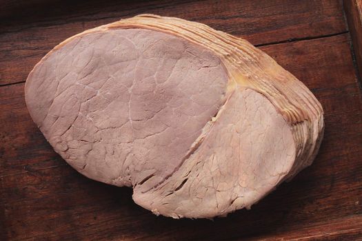 sliced roast beef on wooden platter