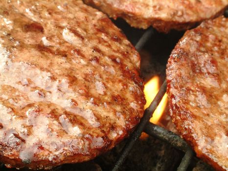 burgers cooking on barbecue