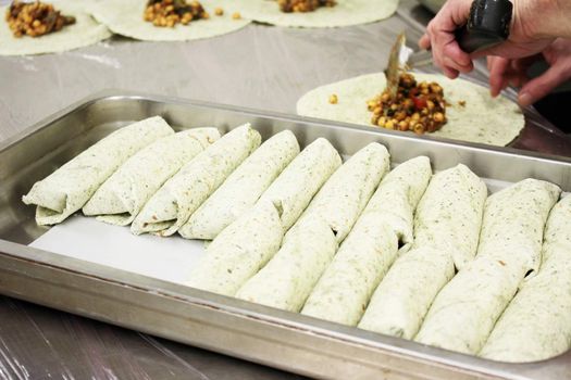 chef preparing indian chick pea wrap