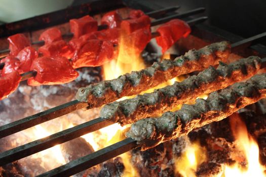 Indian kebabs cooking over coal barbecue