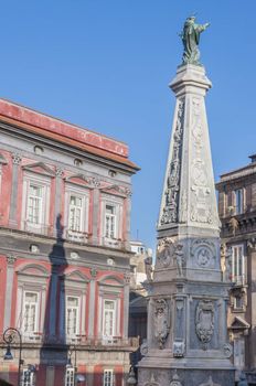 view of famous San Domenico Maggiore square and the big monument at the center, Naples, Italy