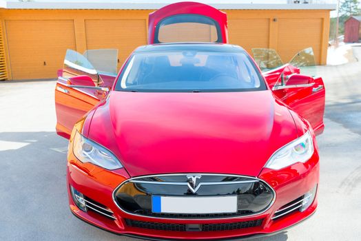 ASKER, NORWAY - MARCH 31: Tesla Motors model S sedan electric red car on March 31, 2015. Tesla's new Gigafactory would help Tesla increase its monthly production volume to 20,000 cars per month.