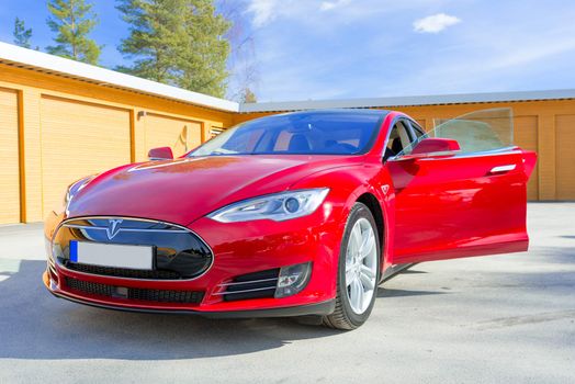 ASKER, NORWAY - MARCH 31: Tesla Motors model S sedan electric red car on March 31, 2015. Tesla's new Gigafactory would help Tesla increase its monthly production volume to 20,000 cars per month.