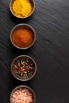 Spices in bowl on stone background