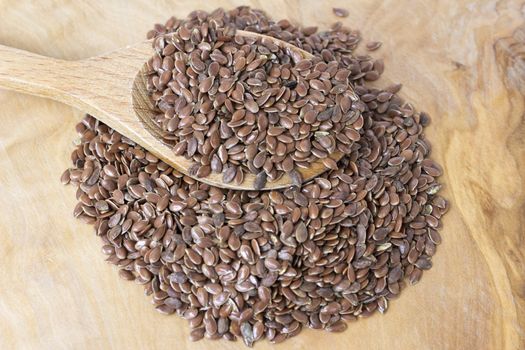 Flax seeds with a wooden spoon-close up