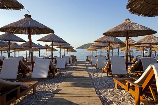   the photographed wooden umbrellas located in the territory of a beach