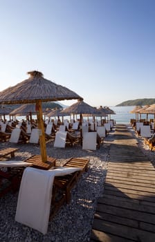   the photographed wooden umbrellas located in the territory of a beach